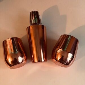 Copper cocktail shaker and two copper cups to shake your drinks up,